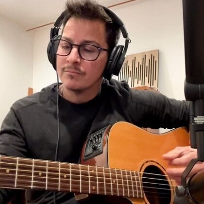 Mar, practicing guitar with headphones and microphone