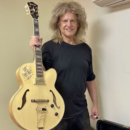 Pat Metheny holding guitar