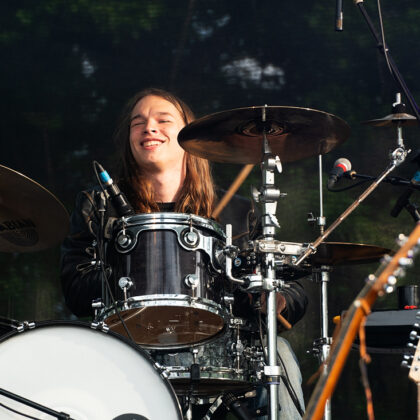 smiling drummer behind kit