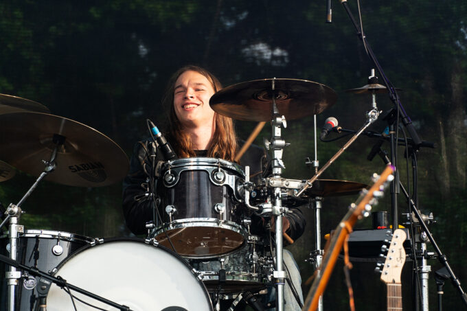 smiling drummer behind kit