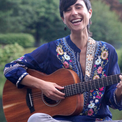 woman smiling with guitar