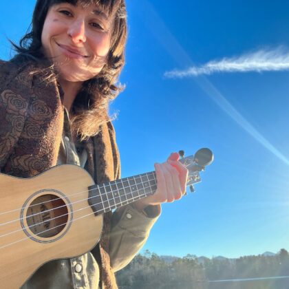 musician with ukulele, blue skies