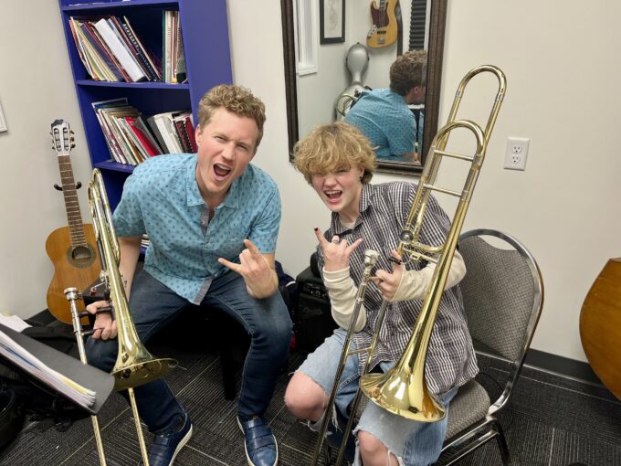 trombone student and teacher, rock face