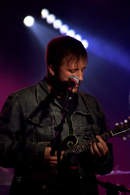 man playing mandolin on stage