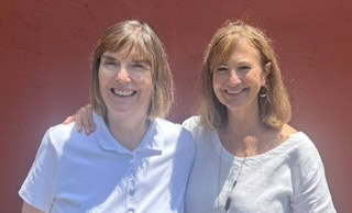 2 women posing for picture